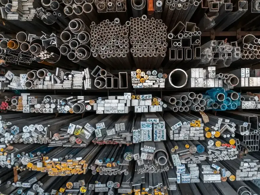 Aluminium and steel profiles racked and sorted by size.