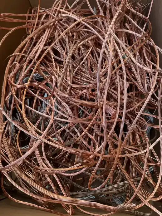 A bin of bare bright copper wire piled up ready for weighing.