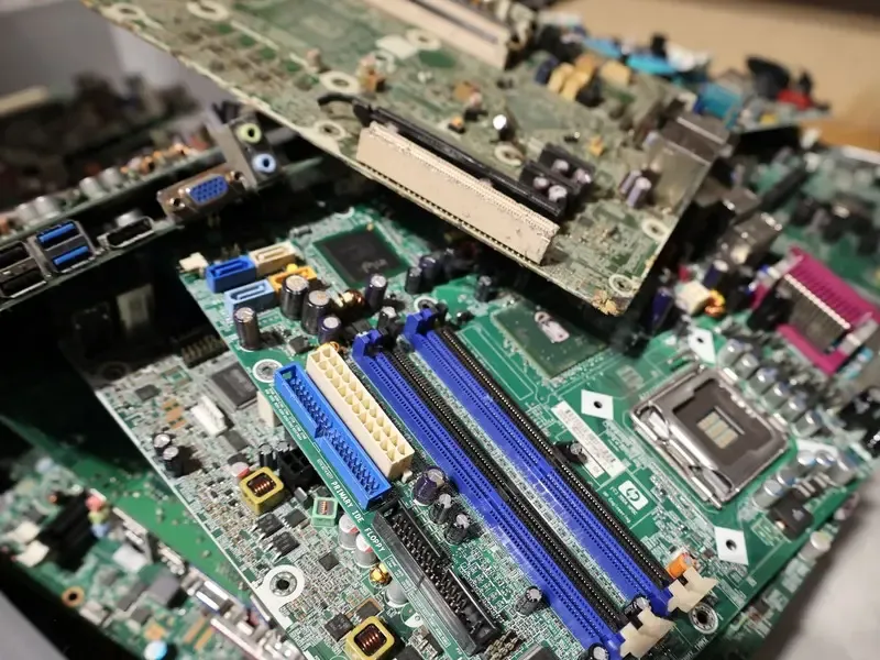 Stripped circuit boards and computer parts collected for metal recovery.