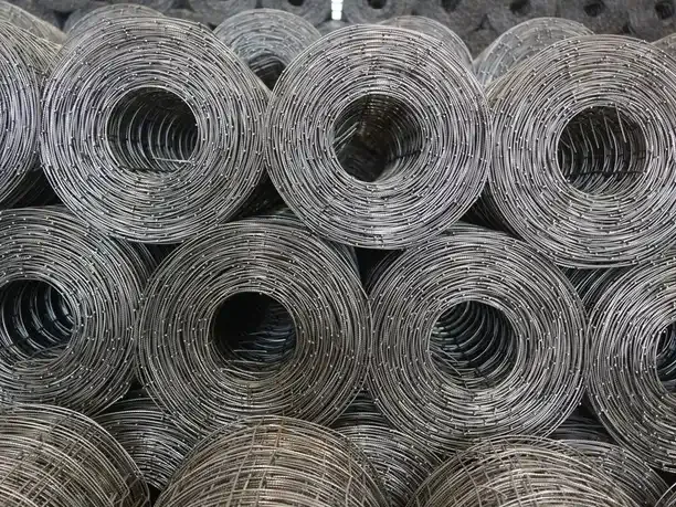 Rolled grey metal coils stacked and kept separate for weighing.